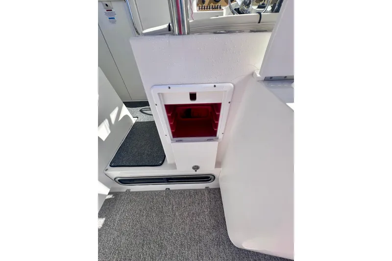 Slide: The Image of 2001 Wellcraft 290 Coastal interior with red storage compartment and carpeted flooring. - 29