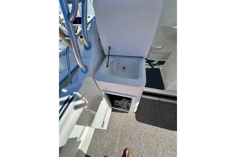 Slide: The Image of 2001 Wellcraft 290 Coastal boat interior with sink and storage compartment. - 30