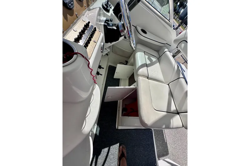 Slide: The Image of 2001 Wellcraft 290 Coastal boat interior with steering wheel and seating area. - 6
