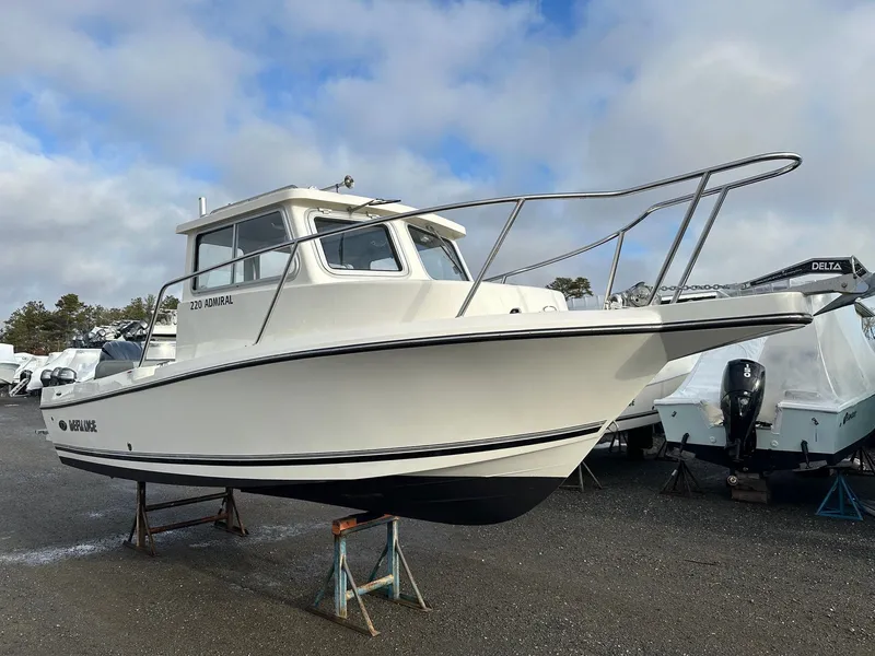 Slide: The Image of 2024 Defiance 220 Admiral EX boat on stands outdoors. - 29