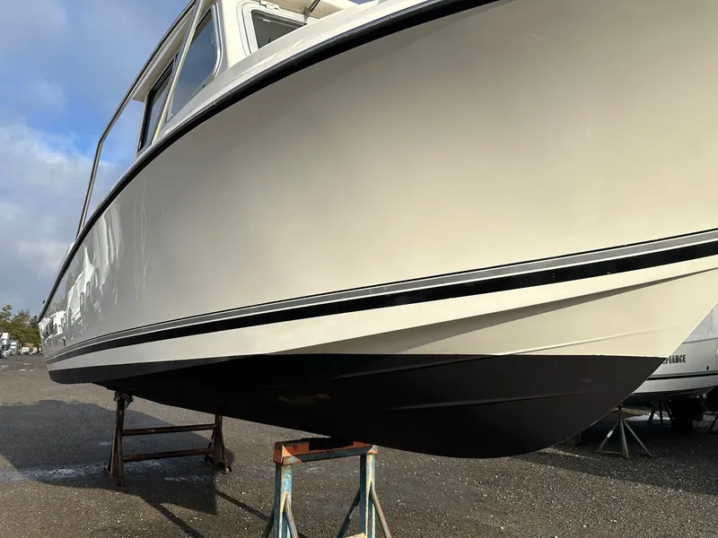 Slide: The Image of 2024 Defiance 220 Admiral EX boat on stands outdoors. - 30