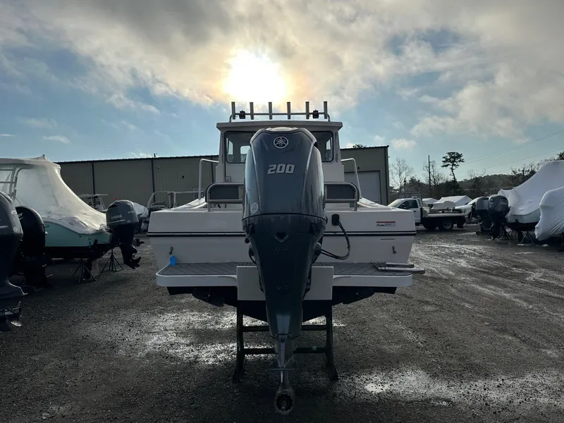 Slide: The Image of Defiance 220 Admiral EX 2024 with outboard motor outdoors. - 35