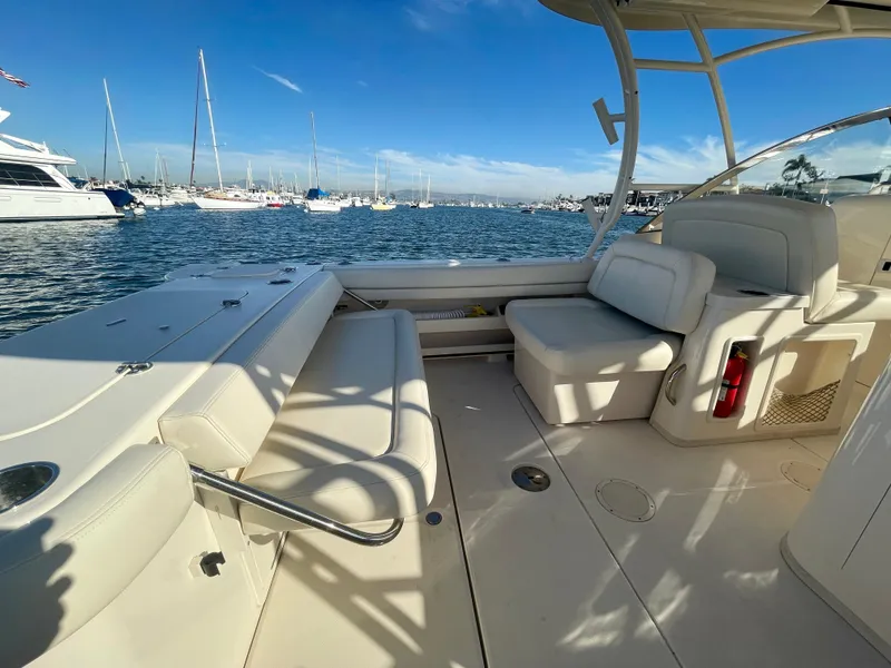 Slide: The Image of 2017 Grady-White 307 Freedom boat interior with seating, docked in a marina. - 10