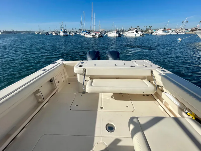 Slide: The Image of 2017 Grady-White 307 Freedom boat on water, spacious deck, clear blue sky. - 13