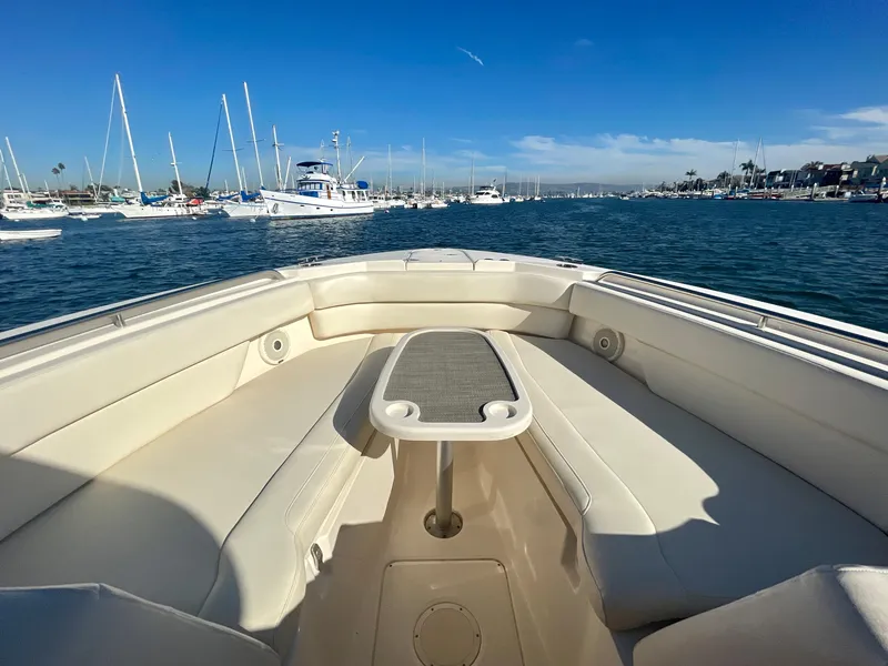 Slide: The Image of 2017 Grady-White 307 Freedom boat interior with ocean view and marina backdrop. - 16