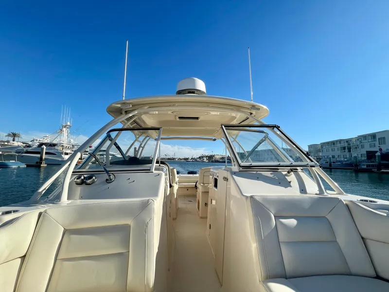 Slide: The Image of 2017 Grady-White 307 Freedom boat interior with clear blue sky and marina view. - 17