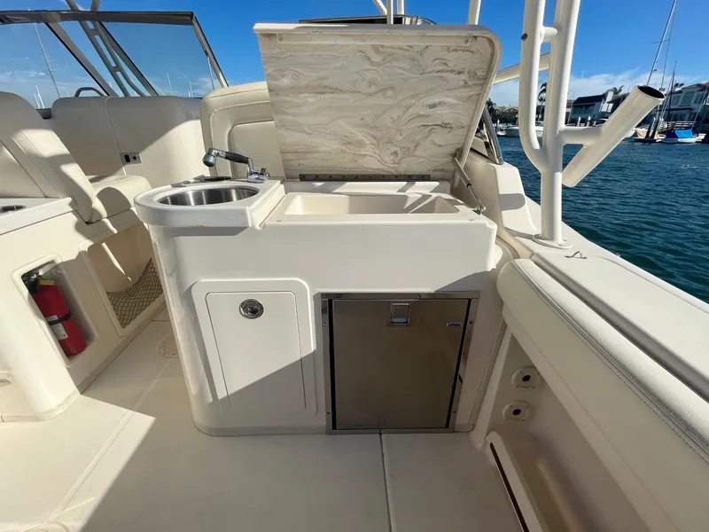Slide: The Image of 2017 Grady-White 307 Freedom boat interior with sink and storage, docked at marina. - 19