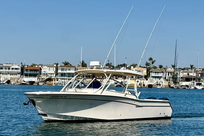 Slide: The Image of 2017 Grady-White Freedom 307 boat cruising on a sunny day near waterfront homes. - 2