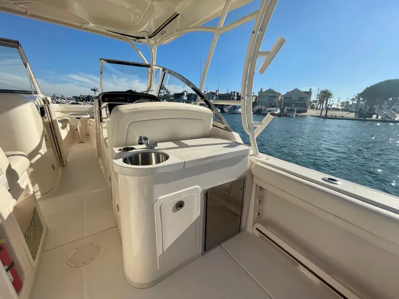 Slide: The Image of 2017 Grady-White 307 Freedom boat interior with sink, overlooking marina. - 21
