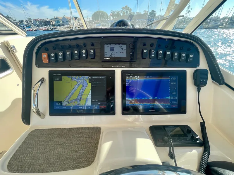 Slide: The Image of Grady-White 307 Freedom 2017 boat dashboard with navigation screens and controls. - 24