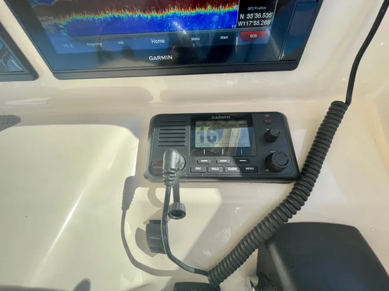 Slide: The Image of Garmin marine radio and display on 2017 Grady-White 307 Freedom boat dashboard. - 25