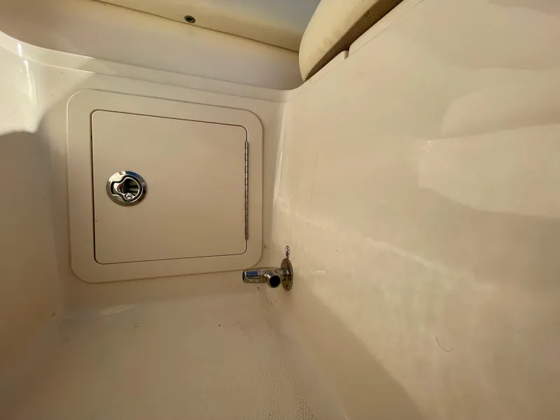 Slide: The Image of Grady-White 307 Freedom 2017 boat storage compartment with latch and clean interior. - 27