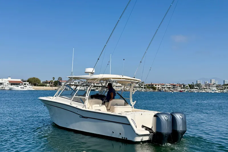 Slide: The Image of 2017 Grady-White Freedom 307 boat cruising on a sunny day near a marina. - 3