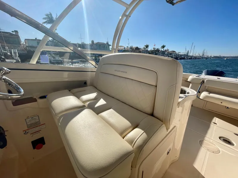 Slide: The Image of 2017 Grady-White 307 Freedom boat interior with beige seating, docked by the water. - 37