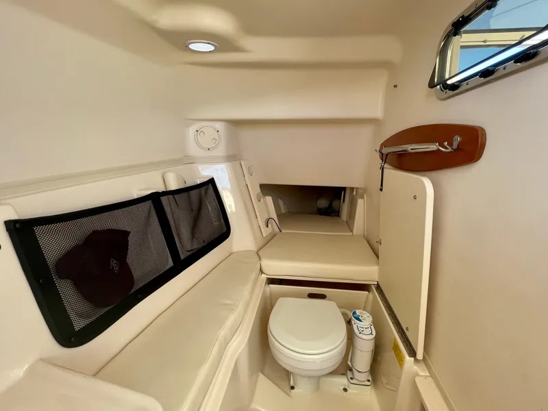 Slide: The Image of 2017 Grady-White 307 Freedom boat cabin interior with seating and toilet. - 47