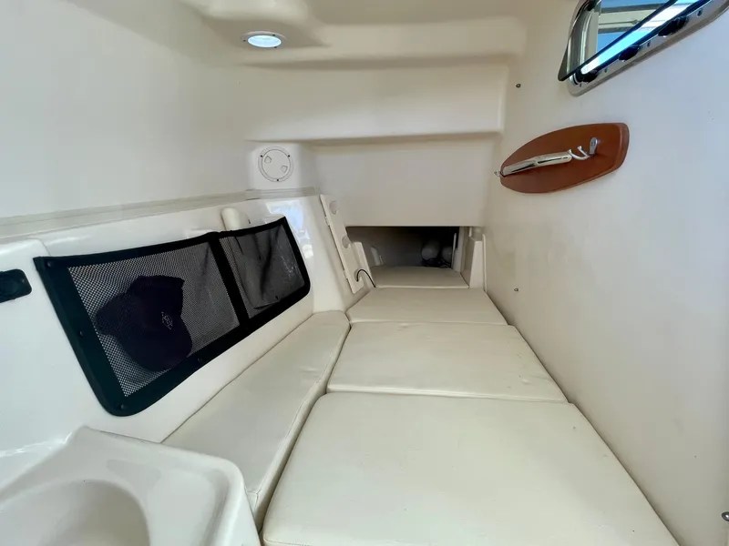 Slide: The Image of Interior cabin of 2017 Grady-White 307 Freedom boat, featuring cushioned seating and storage. - 49