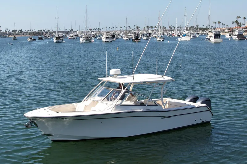 Slide: The Image of 2017 Grady-White Freedom 307 boat on calm water with marina background. - 5
