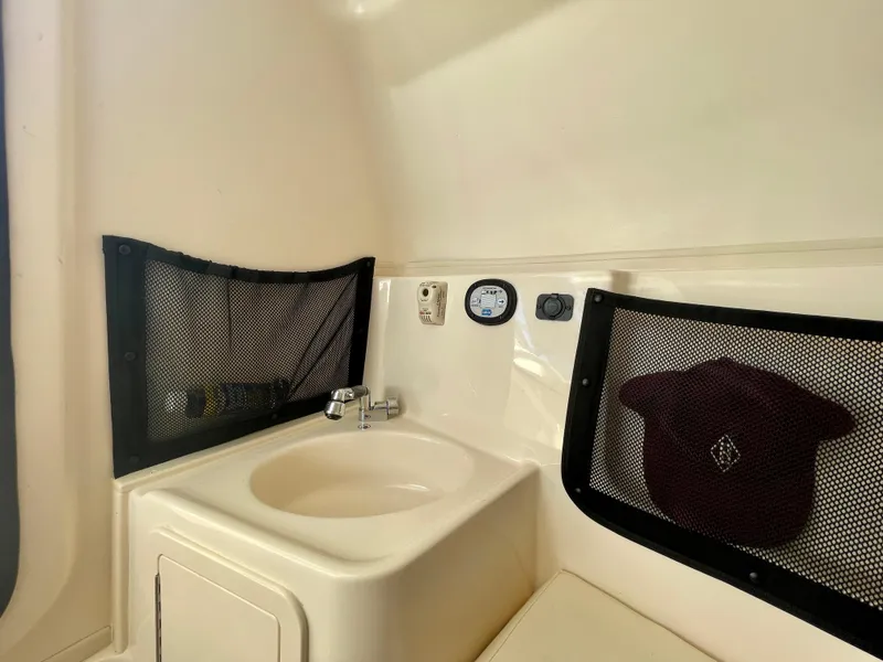 Slide: The Image of 2017 Grady-White 307 Freedom boat interior with sink and storage nets. - 50