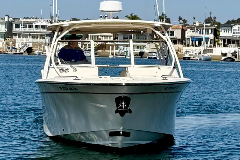 Slide: The Image of 2017 Grady-White Freedom 307 boat on water, with coastal homes in background. - 6