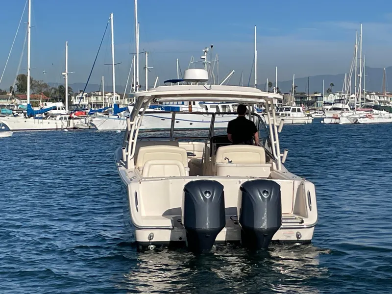 Slide: The Image of 2017 Grady-White 307 Freedom boat with dual engines in a marina setting. - 7