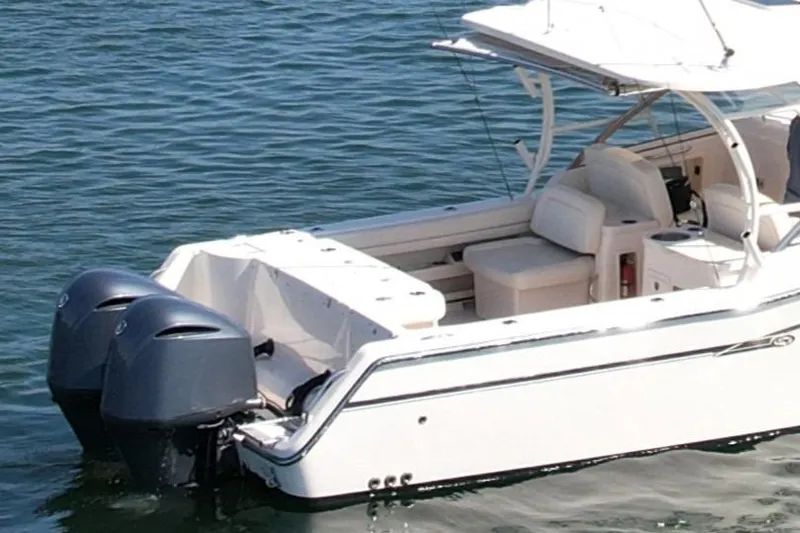 Slide: The Image of 2017 Grady-White Freedom 307 boat with dual outboard motors on water. - 9