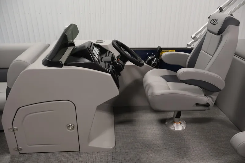 Slide: The Image of 2026 Bentley Pontoons 240 Navigator helm with modern steering and comfortable captain's chair. - 17