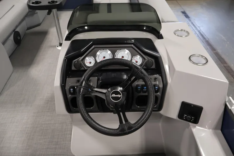 Slide: The Image of 2026 Bentley Pontoons 240 Navigator dashboard with steering wheel and gauges. - 19
