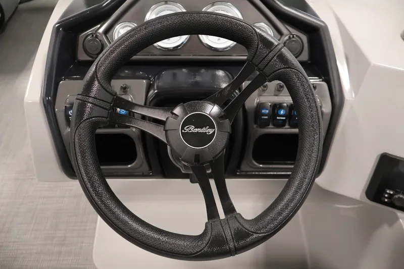 Slide: The Image of Steering wheel of 2026 Bentley Pontoons 240 Navigator with dashboard controls. - 20