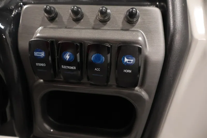 Slide: The Image of Control panel of 2026 Bentley Pontoons 240 Navigator with labeled switches. - 23