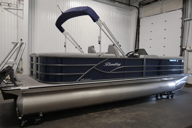Slide: The Image of 2026 Bentley Pontoons 240 Navigator side view, featuring sleek blue panel design. - 38