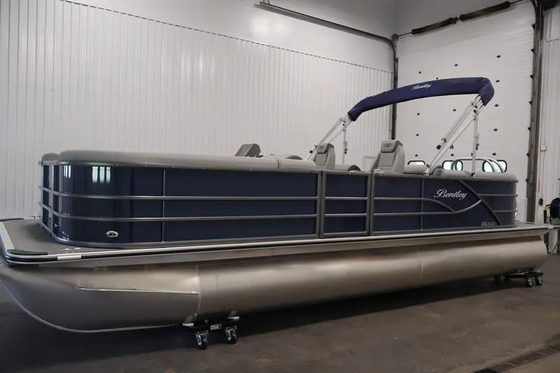 Slide: The Image of 2026 Bentley Pontoons 240 Navigator in a showroom, featuring sleek design and modern amenities. - 7