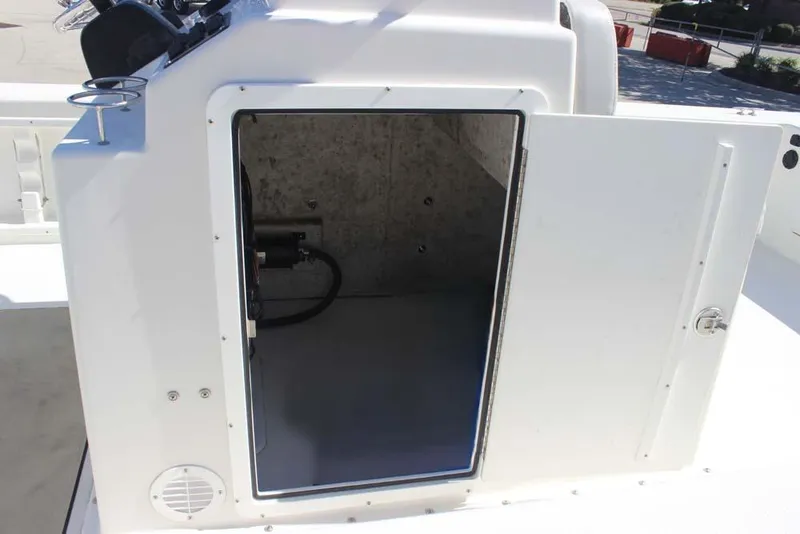 Slide: The Image of 2019 Bay Rider 2060 Skiff storage compartment with open door, showcasing interior space. - 11