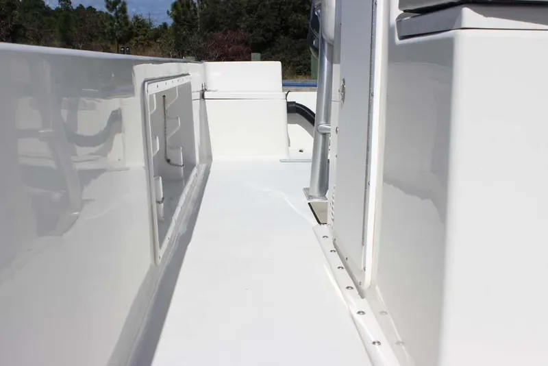 Slide: The Image of 2019 Bay Rider 2060 Skiff deck view, showcasing sleek white design and storage compartments. - 19