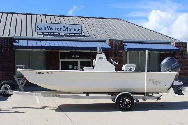 Slide: The Image of 2019 Bay Rider 2060 Skiff boat on trailer outside SaltWater Marine dealership. - 2