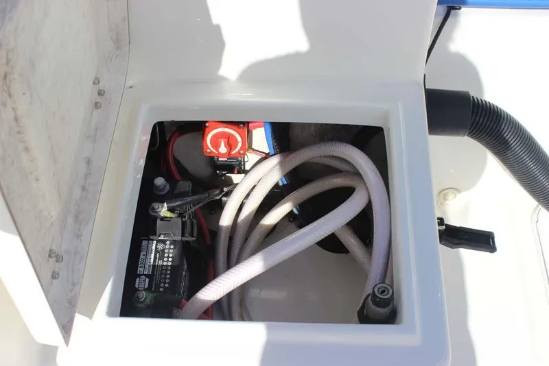 Slide: The Image of 2019 Bay Rider 2060 Skiff battery compartment with cables and switch. - 21