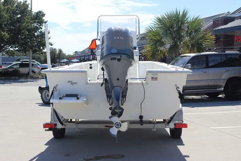 Slide: The Image of 2019 Bay Rider 2060 Skiff boat on trailer, parked outdoors with outboard motor. - 8