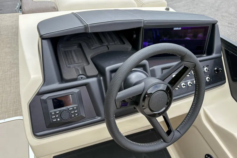 Slide: The Image of 2026 Alera M23L boat dashboard with steering wheel and control panel. - 11