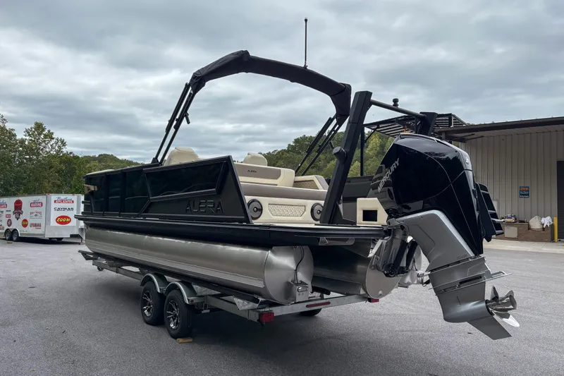Slide: The Image of Alera M23L 2026 pontoon boat with Mercury outboard motor on a trailer. - 3