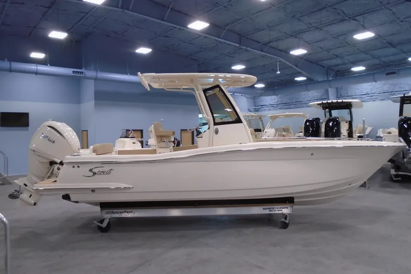 The Image of 2026 Scout 240 XSF boat displayed indoors, showcasing sleek design and powerful engine. - 20