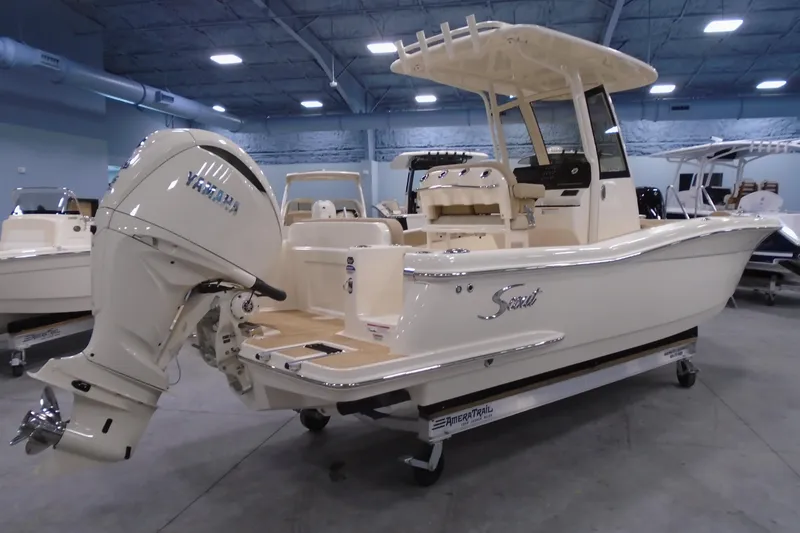 Slide: The Image of 2026 Scout 240 XSF boat with Yamaha engine in showroom setting. - 21