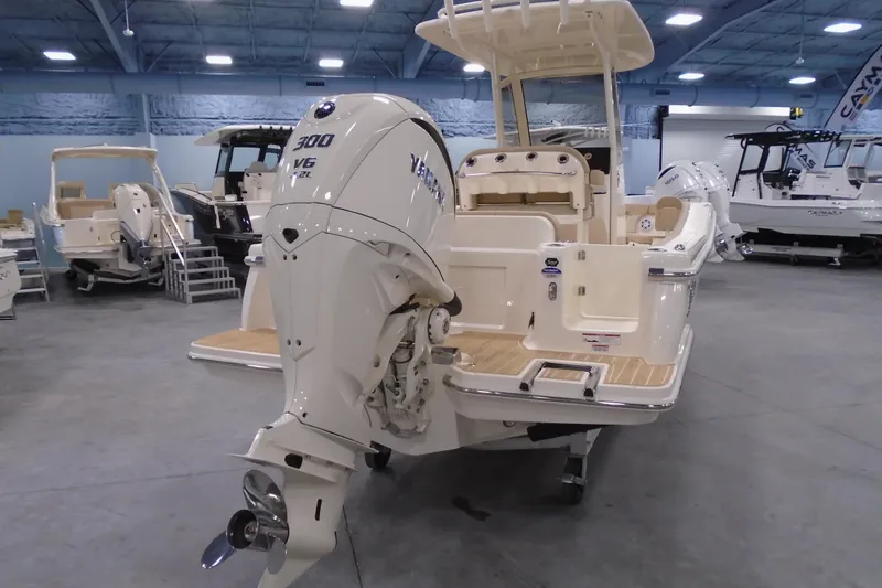 Slide: The Image of 2026 Scout 240 XSF boat with powerful V6 engine displayed in a showroom. - 22