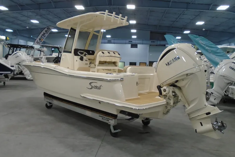 Slide: The Image of 2026 Scout 240 XSF boat with Yamaha engine displayed indoors. - 23