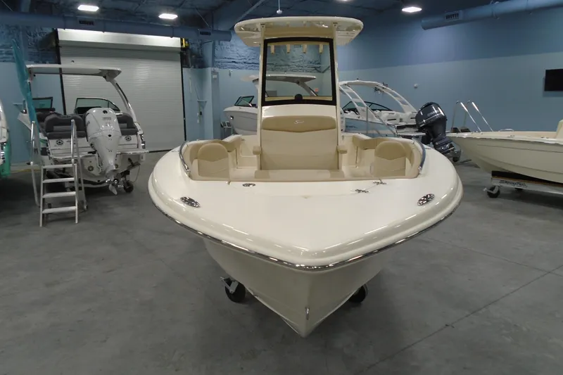 Slide: The Image of 2026 Scout 240 XSF boat displayed in a showroom, featuring sleek design and modern amenities. - 26