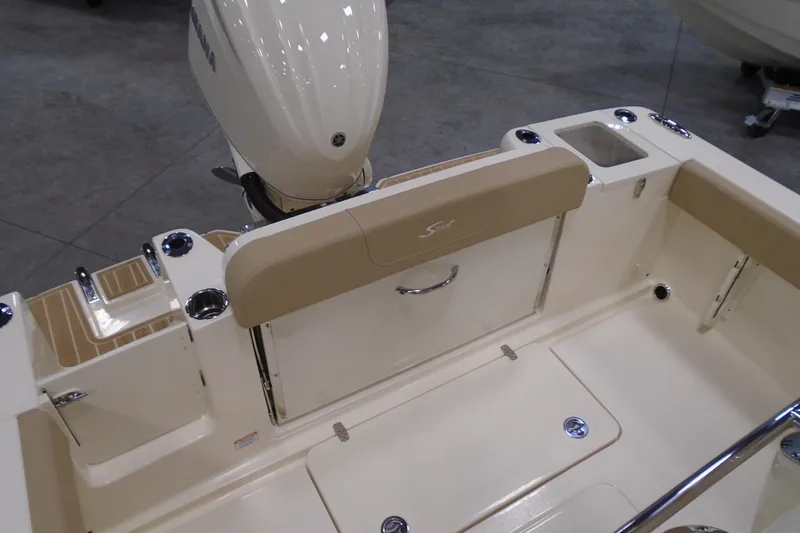 Slide: The Image of 2026 Scout 240 XSF boat interior with Yamaha outboard motor, beige seating, and storage compartments. - 30