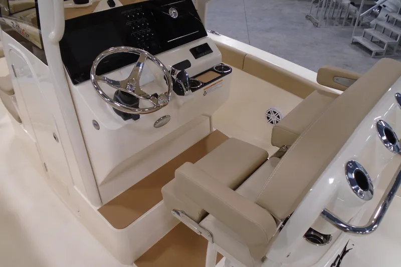 Slide: The Image of 2026 Scout 240 XSF boat interior with steering wheel and beige seating. - 33