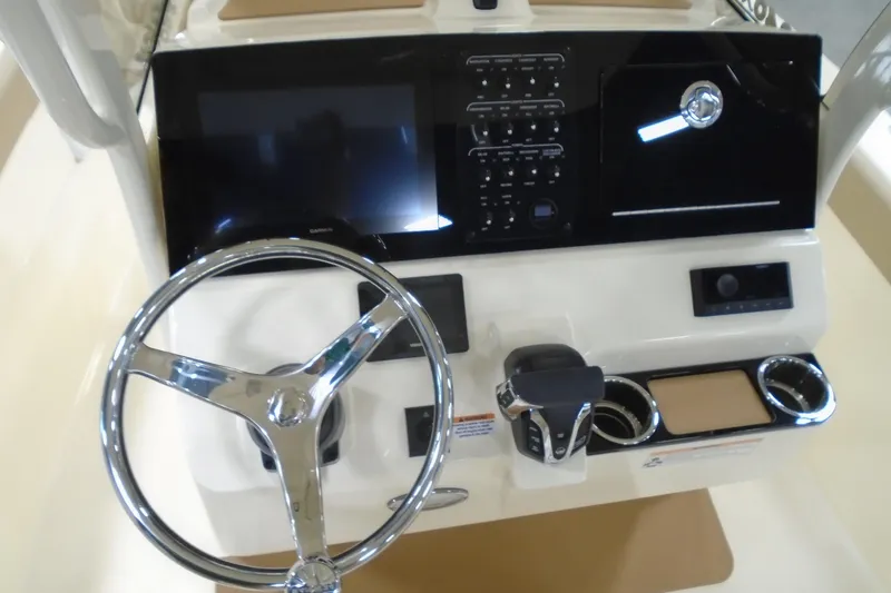 Slide: The Image of 2026 Scout 240 XSF boat dashboard with steering wheel and control panel. - 34