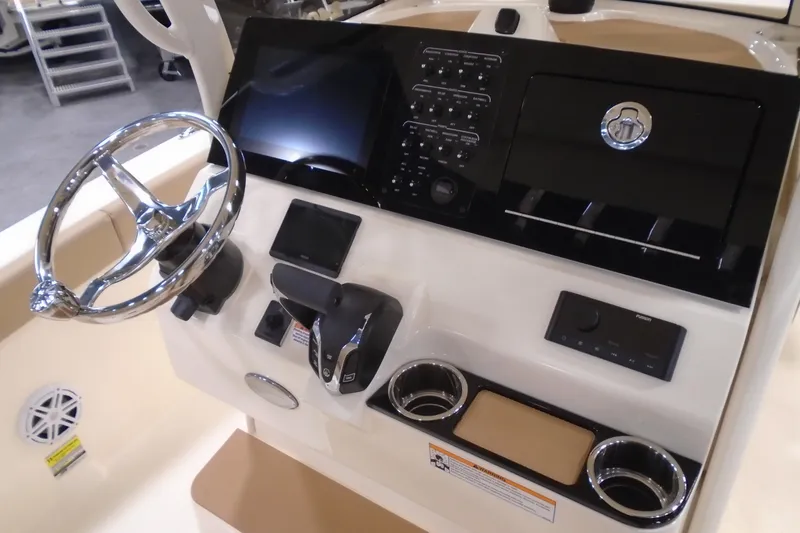 Slide: The Image of 2026 Scout 240 XSF boat dashboard with steering wheel and control panel. - 36