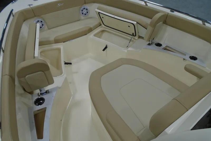 Slide: The Image of 2026 Scout 240 XSF boat interior with beige seating and storage compartments. - 39