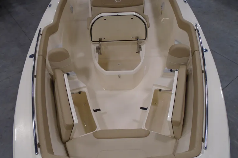 Slide: The Image of 2026 Scout 240 XSF boat interior with beige seating and storage compartments. - 40
