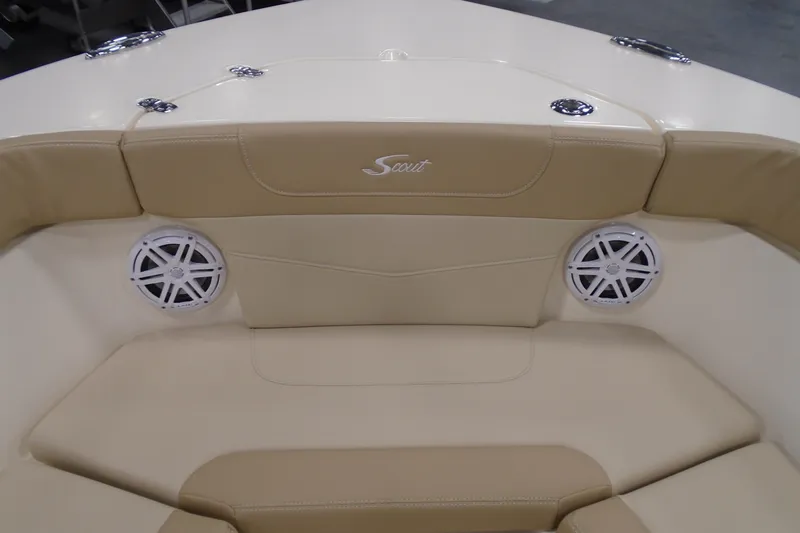 Slide: The Image of 2026 Scout 240 XSF boat interior with beige seating and built-in speakers. - 44